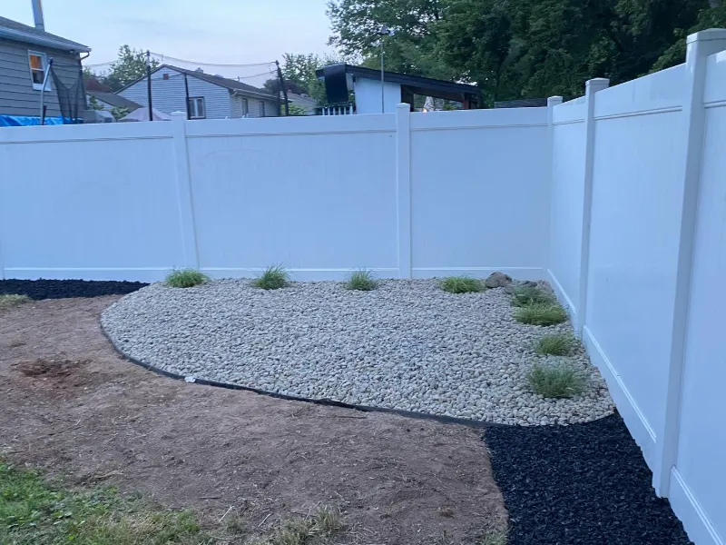 Privacy Fence with River-Rock Bed — TruScapes project in Central Minnesota